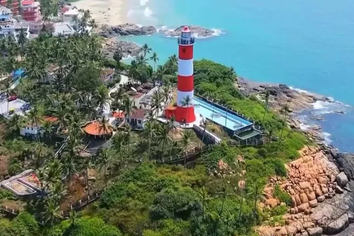 Aerial view of Kovalam lighthouse above the palm-lined Kerala coast.